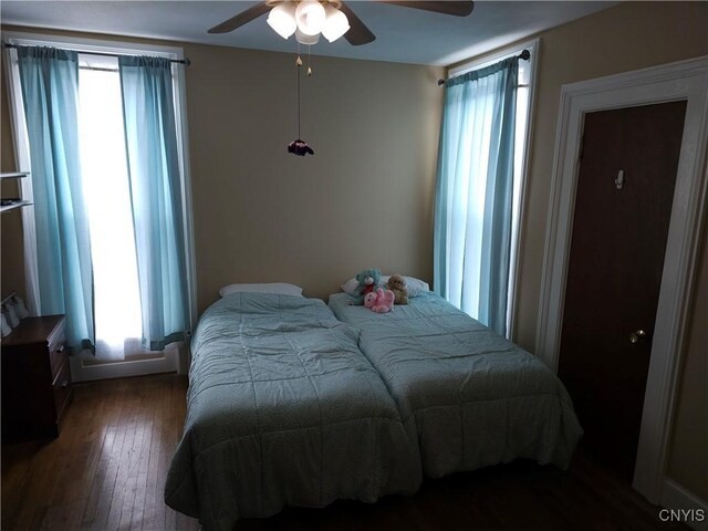 bedroom with ceiling fan and wood-type flooring