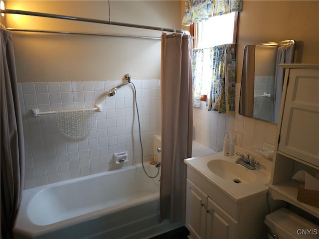 full bath with toilet, tile walls, vanity, and shower / bathtub combination with curtain