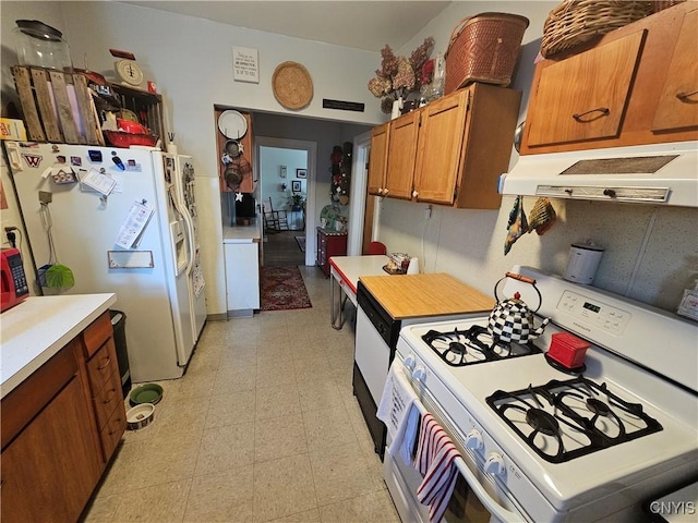 kitchen featuring under cabinet range hood, light floors, light countertops, brown cabinets, and white appliances