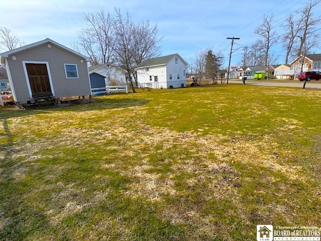 view of yard featuring fence and a residential view