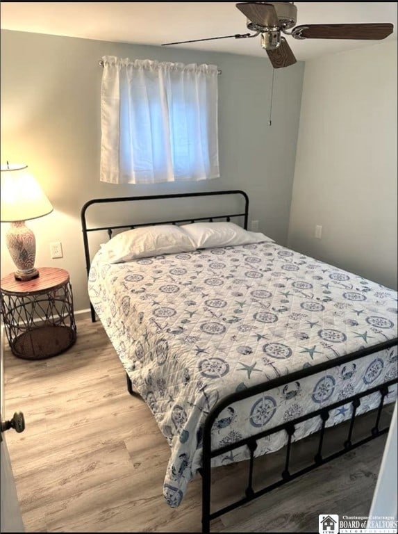 bedroom with ceiling fan and wood finished floors