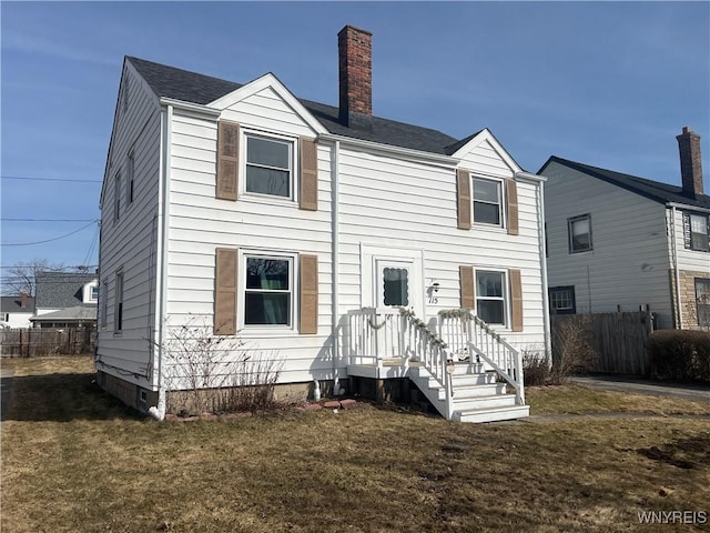 back of house with crawl space, fence, a lawn, and a chimney