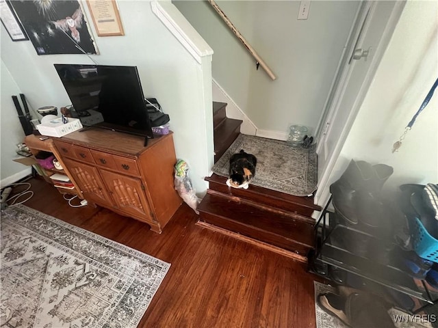 stairway with baseboards and wood finished floors