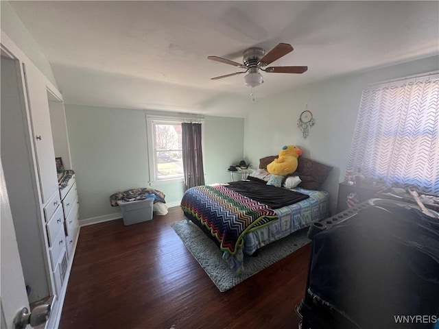 bedroom with ceiling fan, baseboards, and wood finished floors