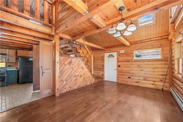 unfurnished living room featuring beam ceiling, a baseboard heating unit, wood finished floors, an inviting chandelier, and wood ceiling