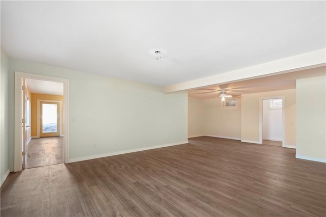 unfurnished room with a ceiling fan, baseboards, and wood finished floors