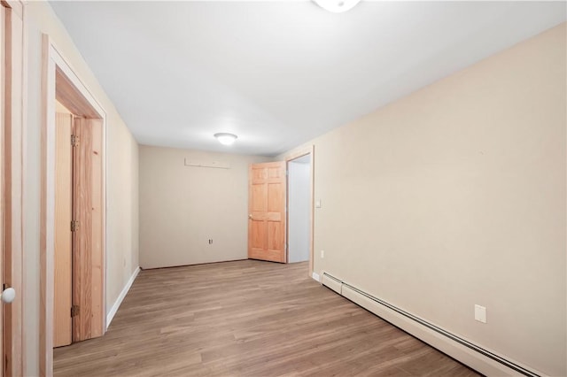 unfurnished bedroom with light wood-style floors and a baseboard radiator