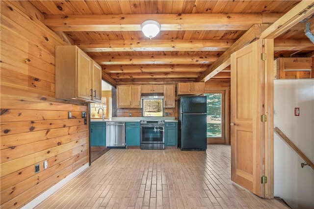 kitchen with light countertops, beamed ceiling, plenty of natural light, and stainless steel appliances