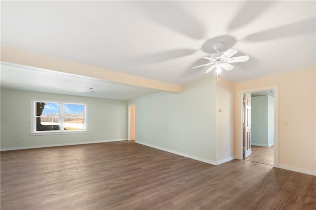 empty room featuring beamed ceiling, ceiling fan, baseboards, and wood finished floors