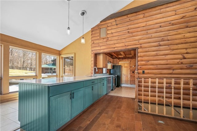 kitchen featuring pendant lighting, a sink, wood finished floors, a peninsula, and dishwasher