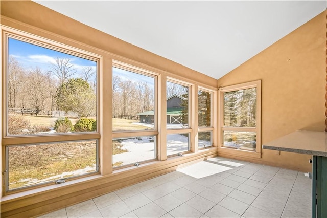 unfurnished sunroom featuring vaulted ceiling