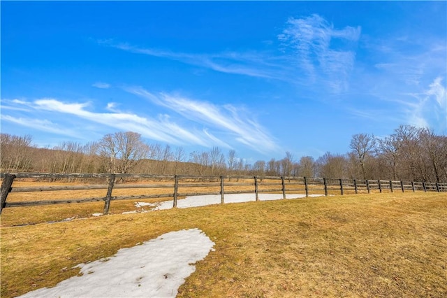 view of yard with a rural view and fence