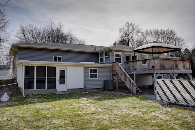 rear view of house with central air condition unit, stairway, a wooden deck, a gazebo, and a yard