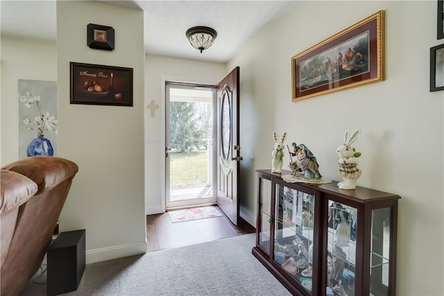 carpeted entryway with baseboards