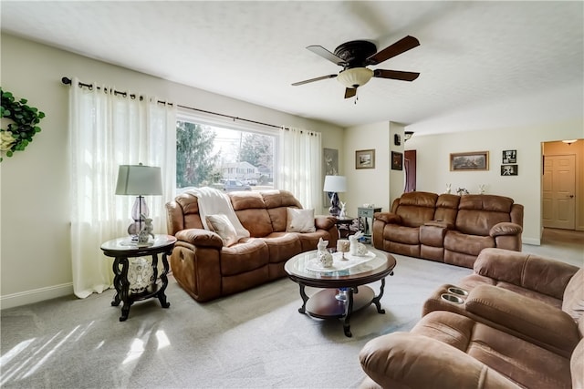 living room featuring vaulted ceiling, baseboards, ceiling fan, and carpet floors