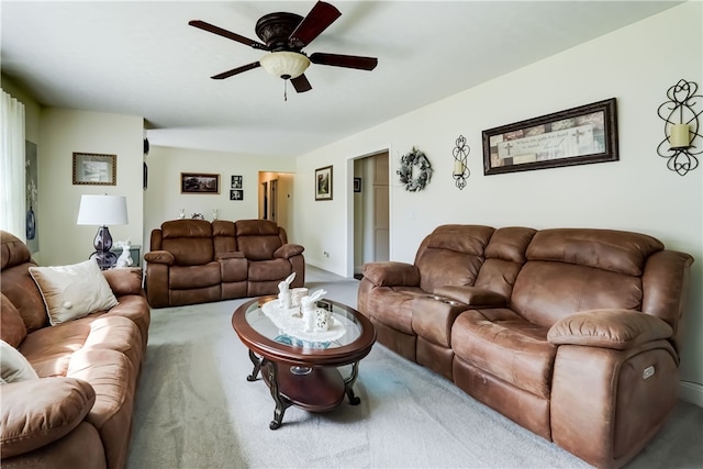 carpeted living room featuring a ceiling fan