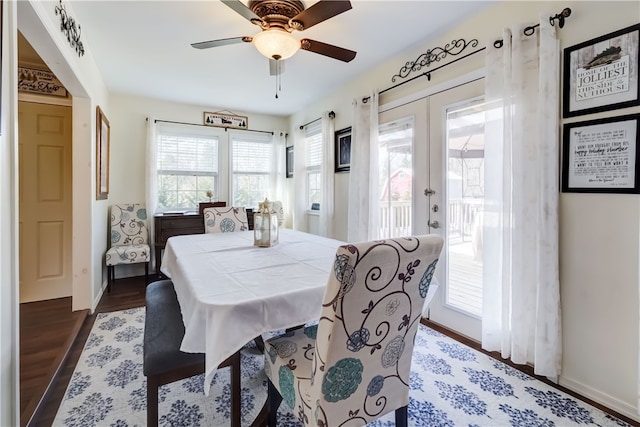 dining room featuring french doors, baseboards, a ceiling fan, and wood finished floors