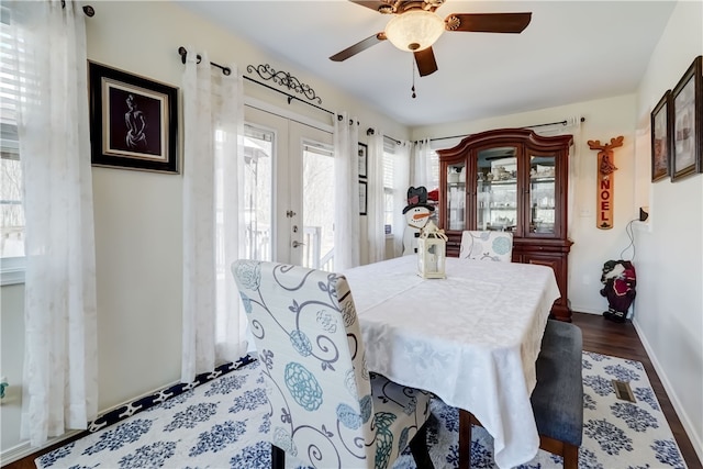 dining space with french doors, baseboards, and a ceiling fan