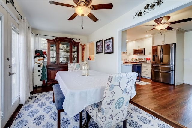 dining space featuring ceiling fan and dark wood-style flooring