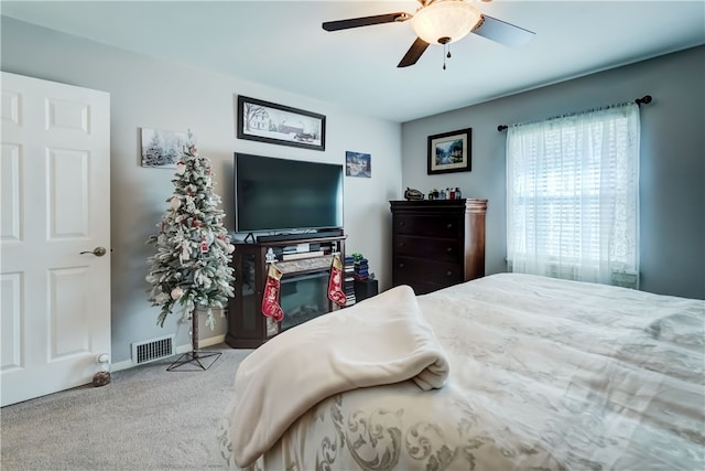 bedroom featuring visible vents, baseboards, carpet, and ceiling fan