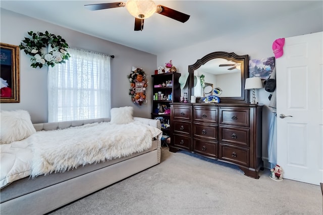 bedroom with light carpet and a ceiling fan