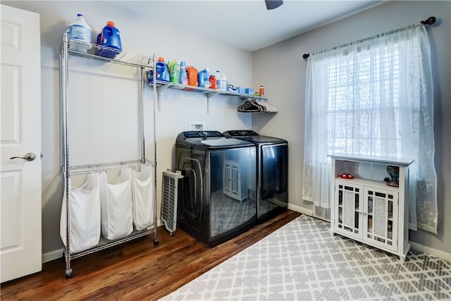 laundry room featuring washer and dryer, laundry area, wood finished floors, and baseboards