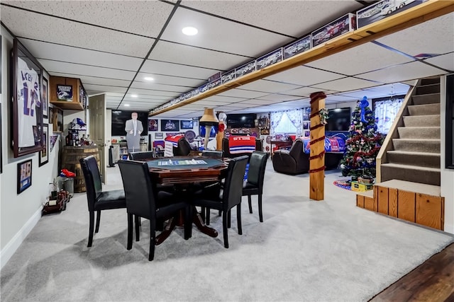 dining room with baseboards, carpet, stairs, recessed lighting, and a paneled ceiling