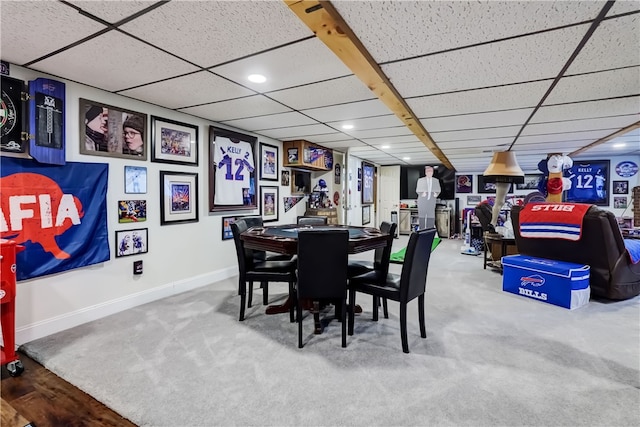 dining space with recessed lighting, carpet, baseboards, and a drop ceiling