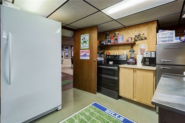 kitchen featuring light brown cabinets, black electric range, a drop ceiling, stainless steel countertops, and freestanding refrigerator