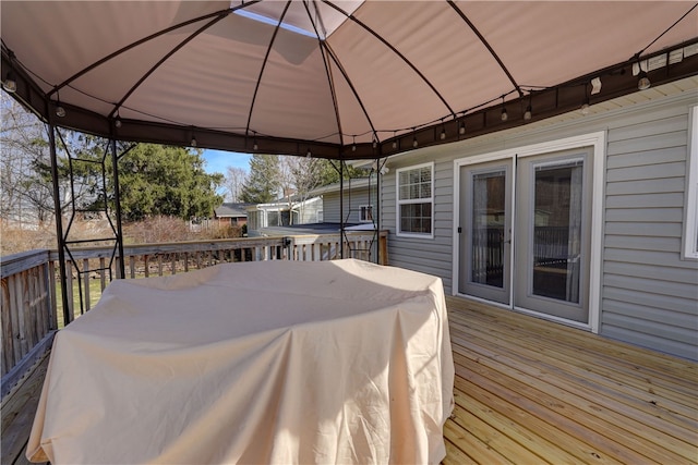 deck featuring a gazebo and outdoor dining space