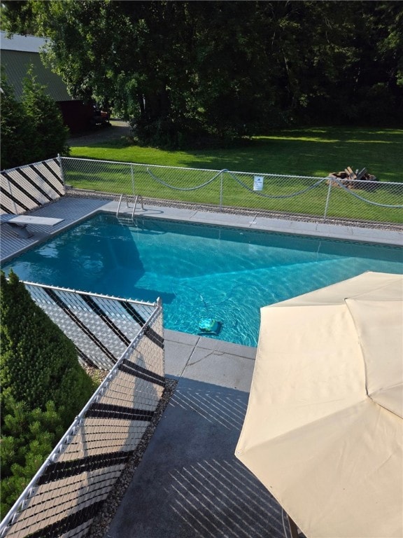 pool featuring fence and a lawn