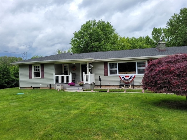 ranch-style home with a porch, a chimney, a front yard, and a shingled roof