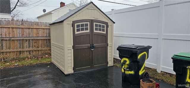 view of shed featuring a fenced backyard