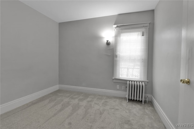 carpeted empty room with baseboards, a healthy amount of sunlight, and radiator heating unit