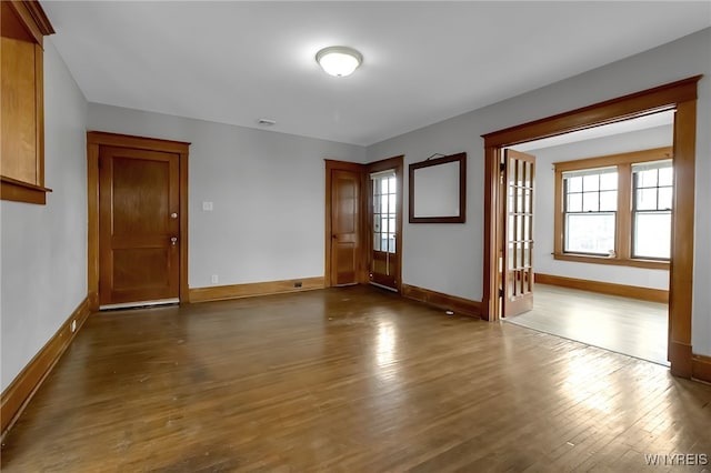 interior space with visible vents, dark wood-style floors, and baseboards