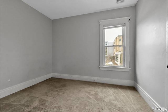 carpeted spare room with baseboards