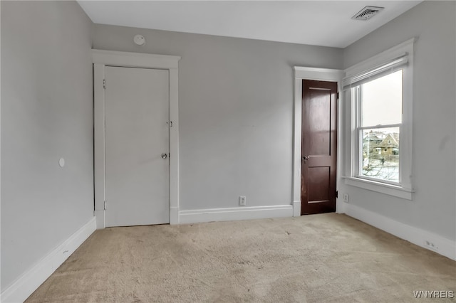 unfurnished bedroom featuring visible vents, baseboards, and carpet