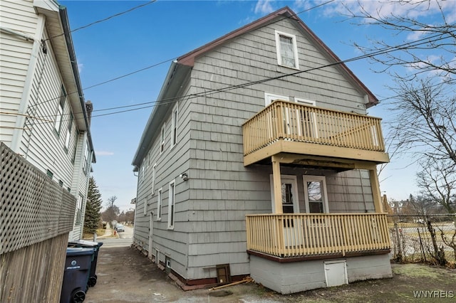 rear view of house featuring a wooden deck