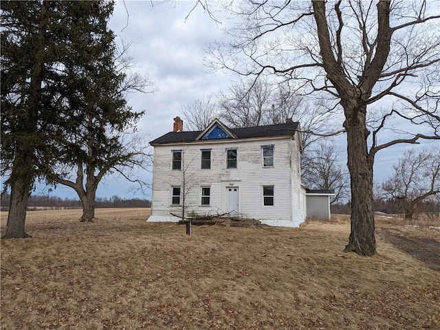 colonial-style house featuring a chimney