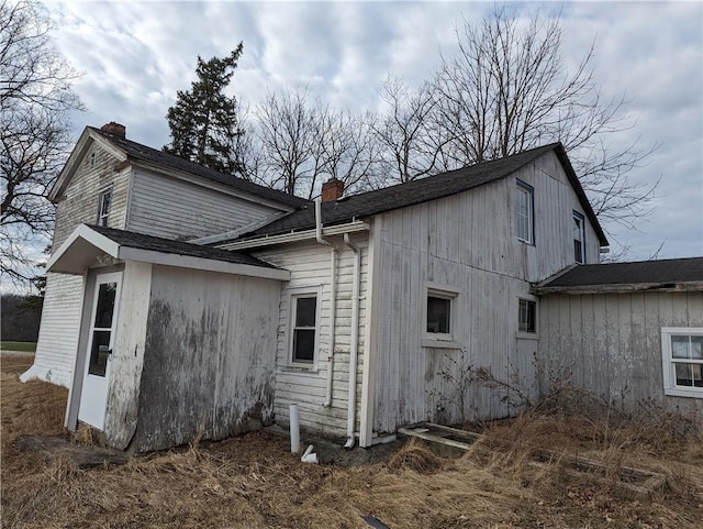 view of side of home with a chimney