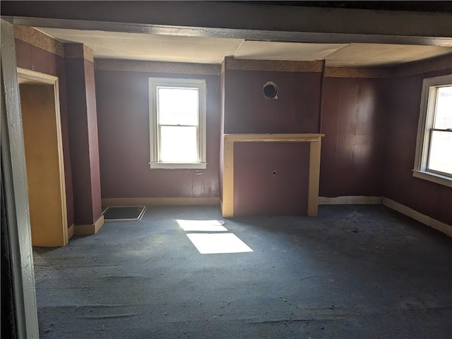 empty room with baseboards and plenty of natural light