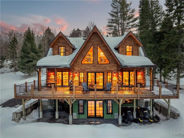 1392 Big Moose Rd, Webb, NY 13331 - snow covered rear of property featuring a wooden deck and log siding