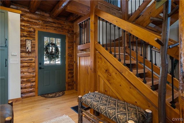 1392 Big Moose Rd, Webb, NY 13331 - entrance foyer featuring wood finished floors, wooden ceiling with exposed beams, rustic walls, and stairway