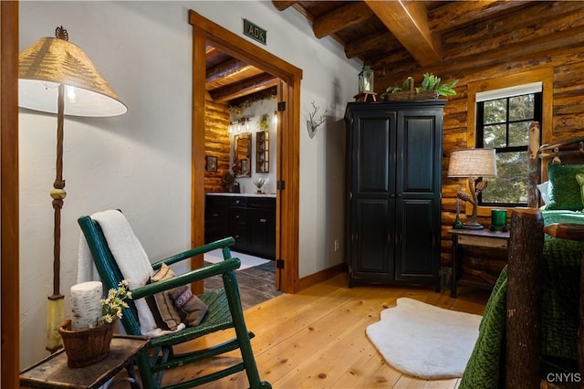 1392 Big Moose Rd, Webb, NY 13331 - sitting room with beam ceiling, light wood-type flooring, and log walls