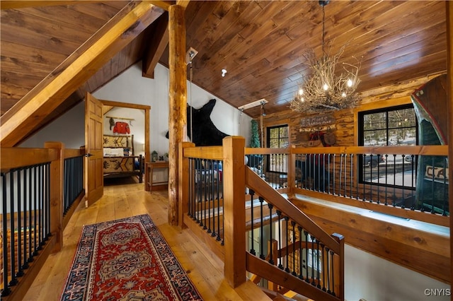 1392 Big Moose Rd, Webb, NY 13331 - hallway featuring an upstairs landing, wood ceiling, a chandelier, and hardwood / wood-style floors