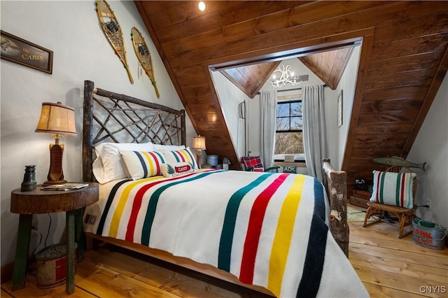 1392 Big Moose Rd, Webb, NY 13331 - bedroom with wood-type flooring, a chandelier, lofted ceiling, and wood ceiling