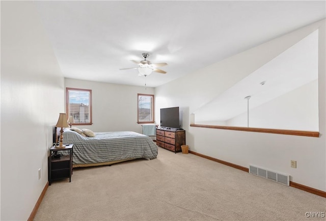 carpeted bedroom with visible vents, a ceiling fan, and baseboards