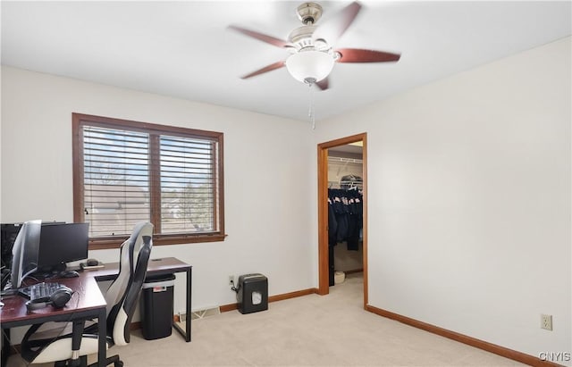 home office with baseboards, light carpet, and a ceiling fan