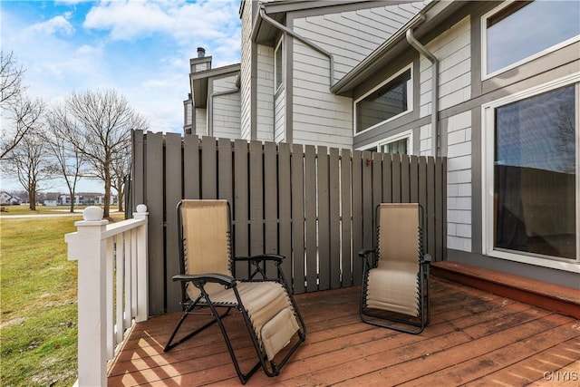 wooden deck with a yard and fence