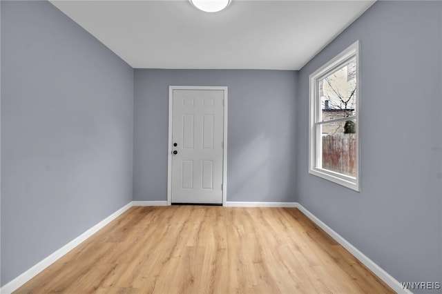 unfurnished room featuring light wood-style flooring and baseboards